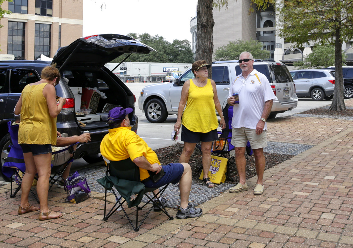 LSU fans sit in the parking lot near Tiger Stadium